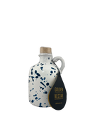 Short, white ceramic container, speckled with blue paint, containing Golden Nectar, Organic, Extra Virgin, Olive Oil