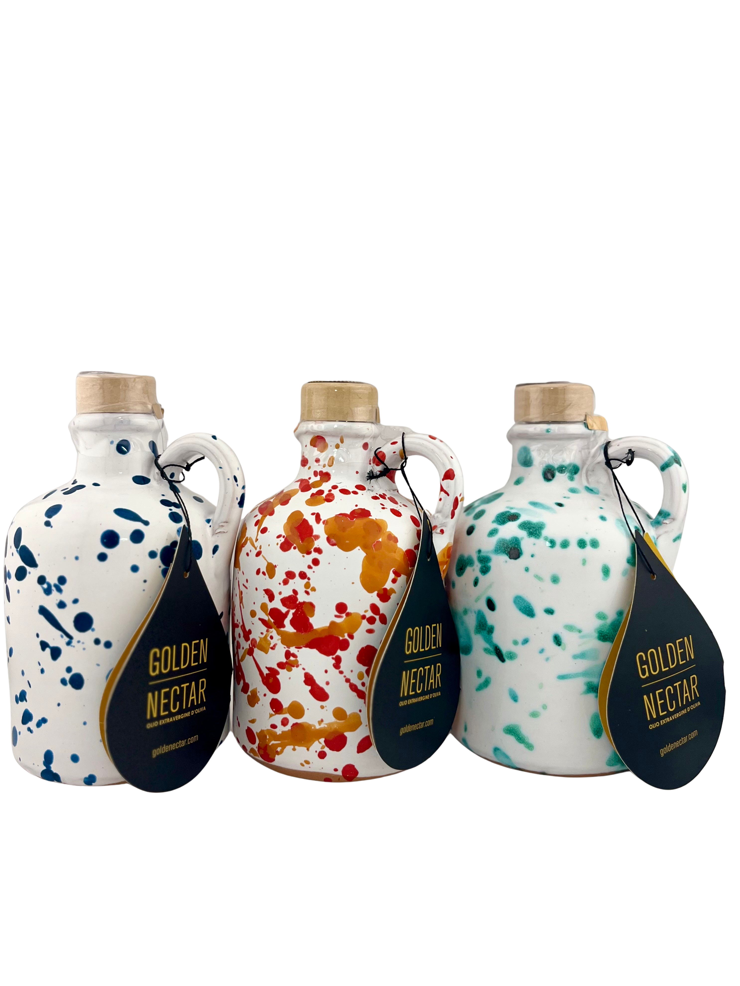 A collection of short white ceramics containing Golden Nectar, Organic, Extra Virgin, Olive Oil. One is speckled with dark blue paint, one speckled with orange paint and one with turquoise paint