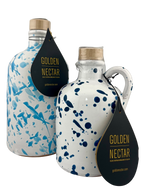 Tall, white ceramic container, speckled with light blue paint, alongside short white ceramic container speckled with dark blue paint, both containing Golden Nectar, Organic, Extra Virgin, Olive Oil