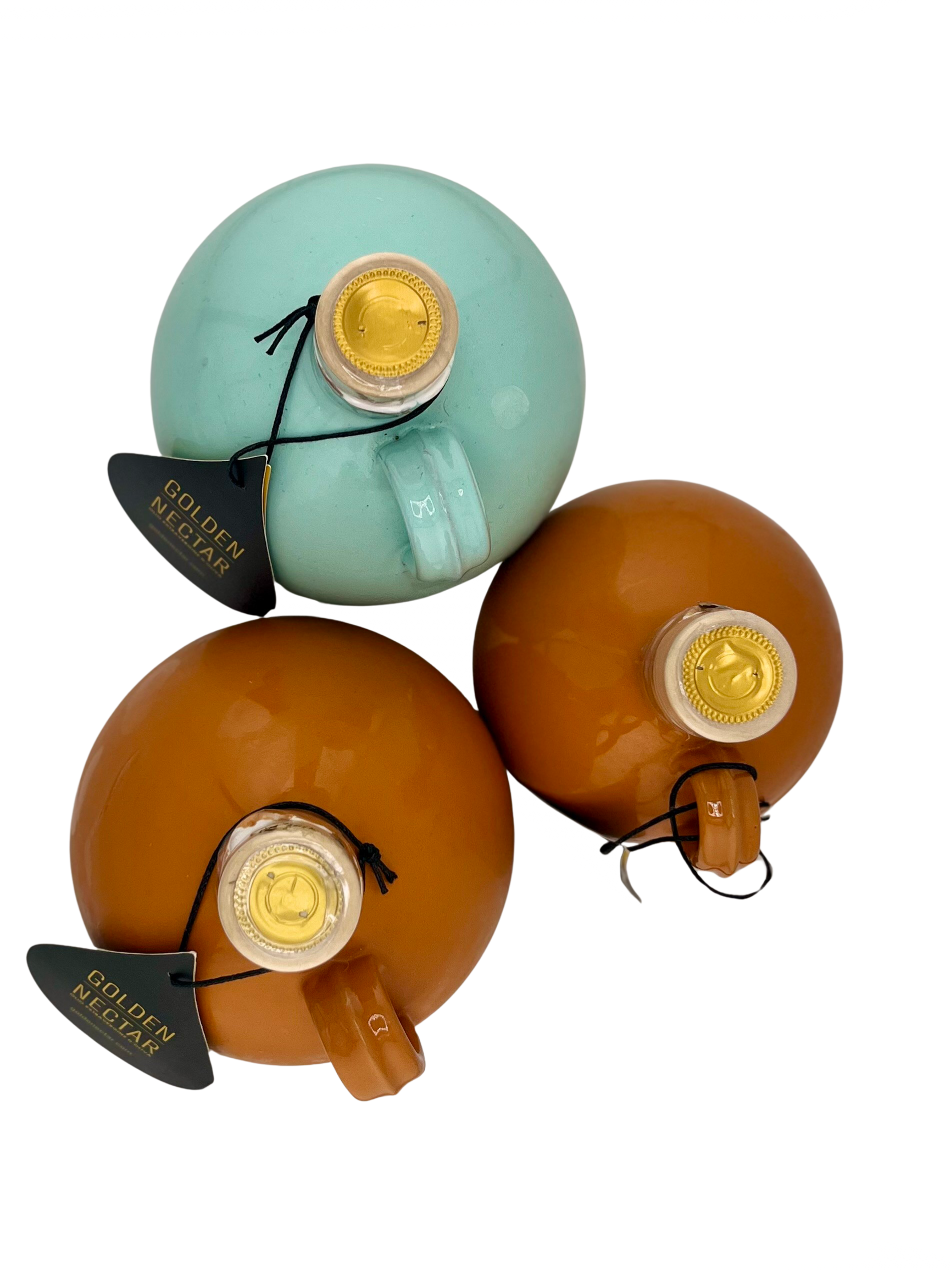 A collection of round, painted ceramic containers, of various colours, containing olive oil