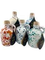 A collection of white ceramics all different sizes with different colored speckled designs and containing Golden Nectar, Organic, Extra Virgin, Olive Oil