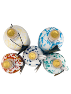 A collection of white ceramics all different sizes with different colored speckled designs 