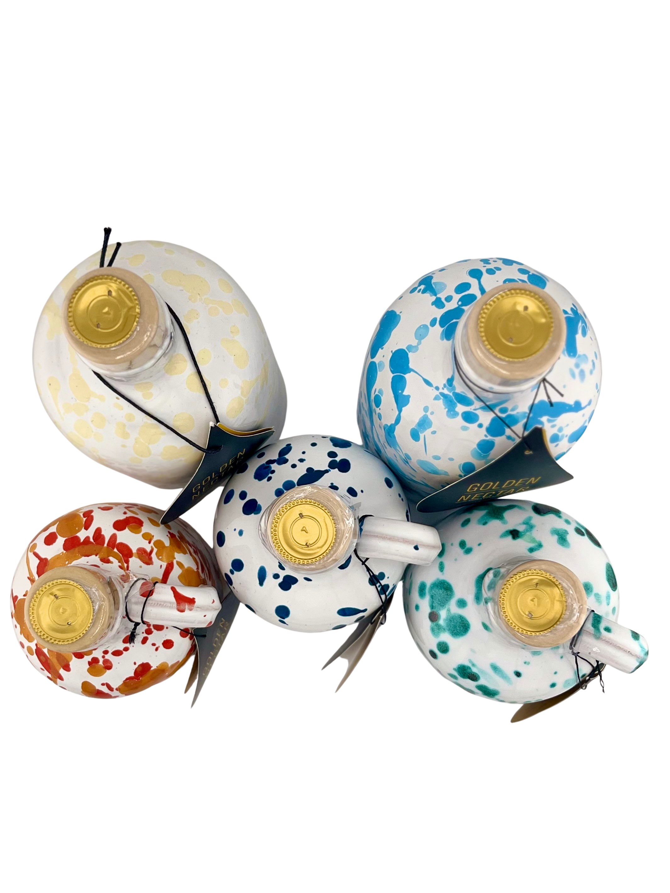 A collection of white ceramics all different sizes with different colored speckled designs 